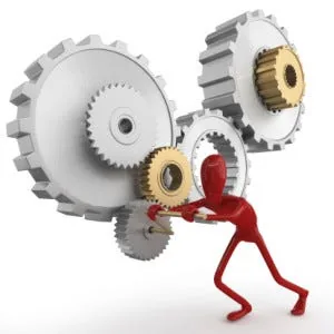 Red 3D figure straining to turn interlocking silver and gold gears